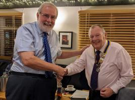 On behalf of Michael Chapman (Past President 2021/22), Willie Fraser is seen handing the Presidency of Dunmow Rotary Club over to Colin Bradley for 2022/23.
